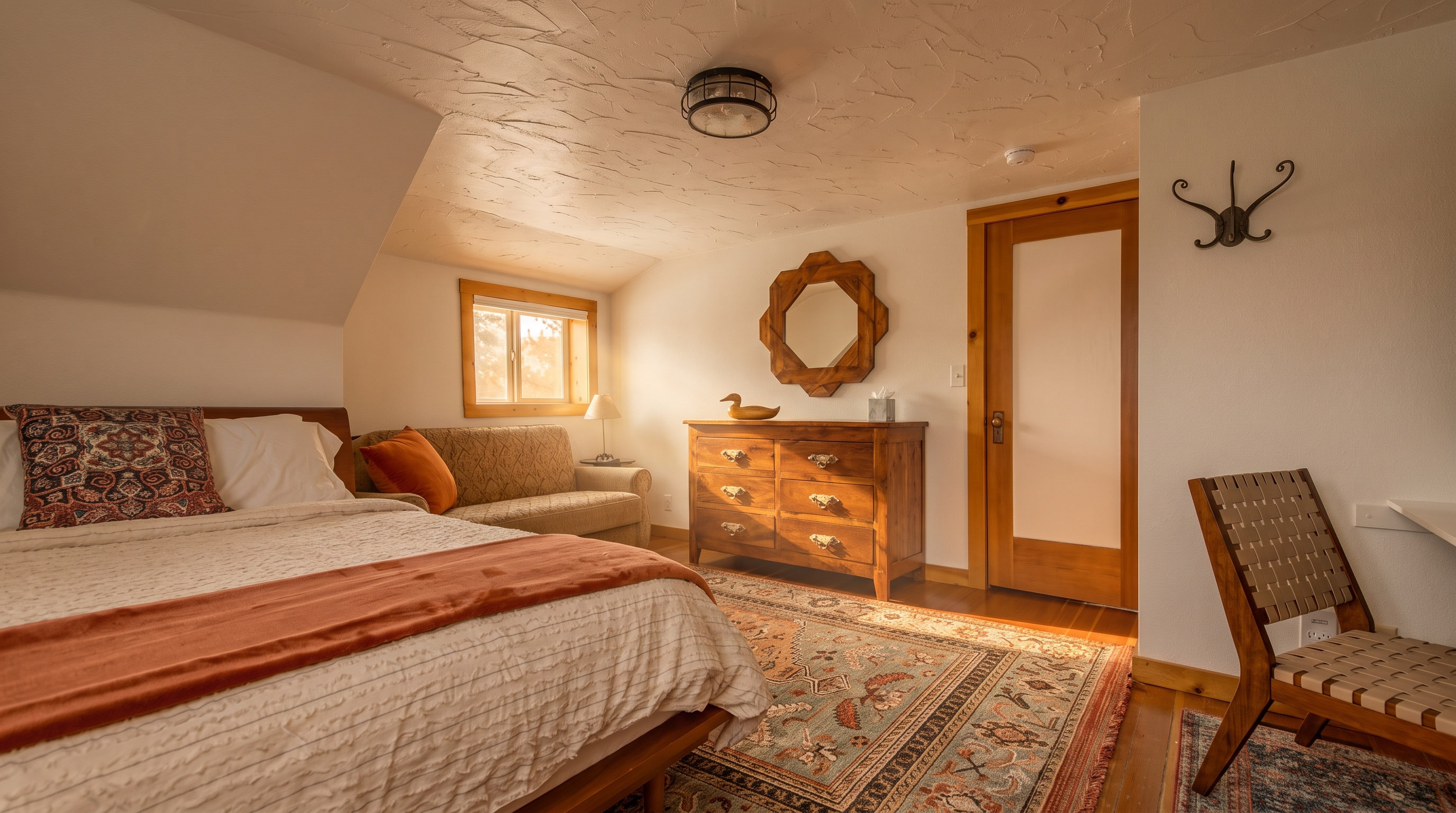 Upstairs Bedroom 1 — main view with antique dresser and carved wood mirror