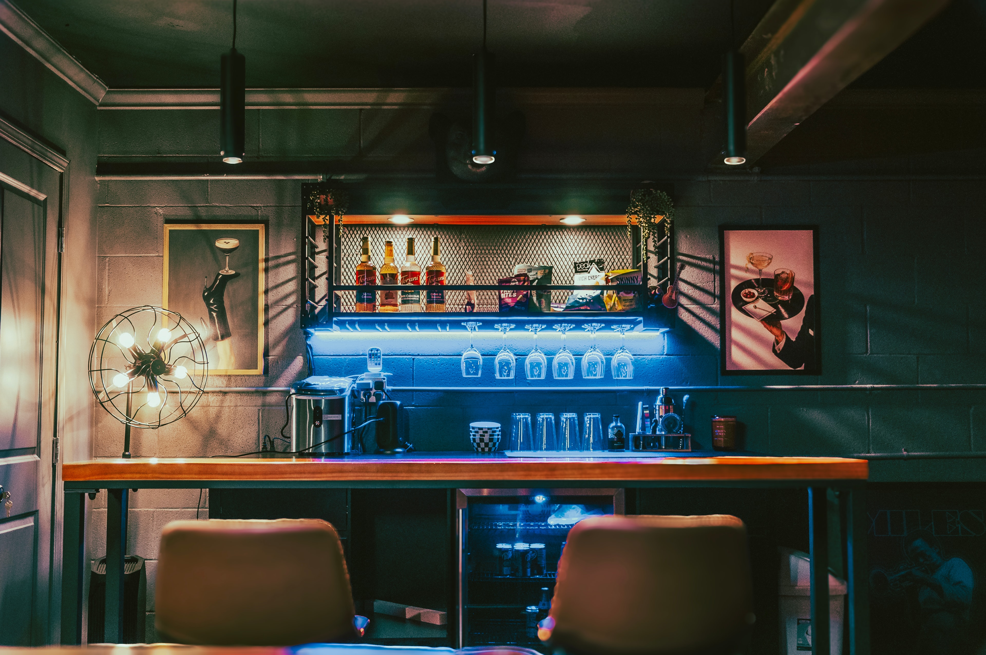 Game Room — cocktail bar with blue LED backlighting and spirits shelf