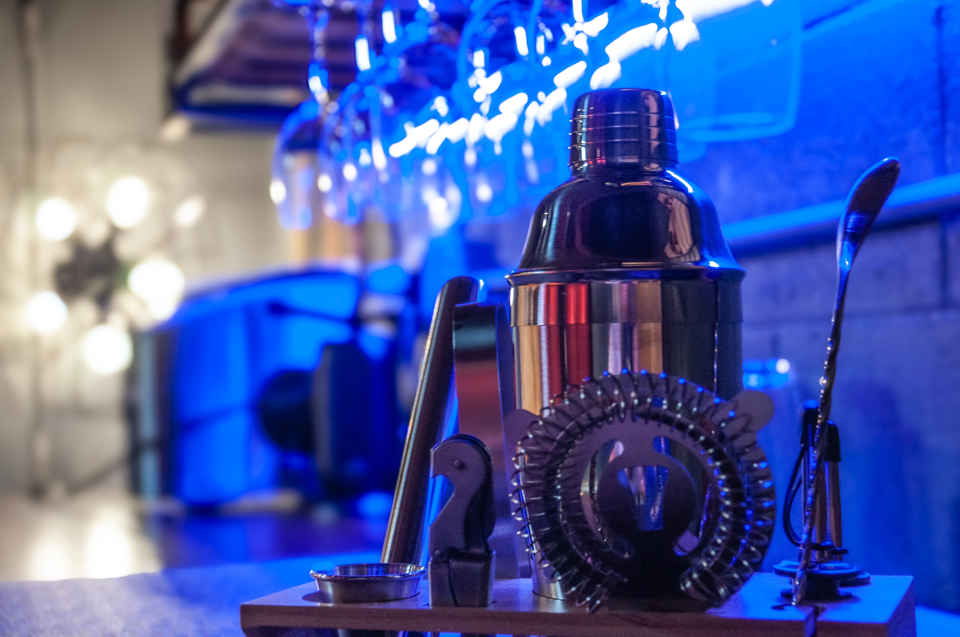 Game Room — cocktail shaker and bar tools under blue neon glow
