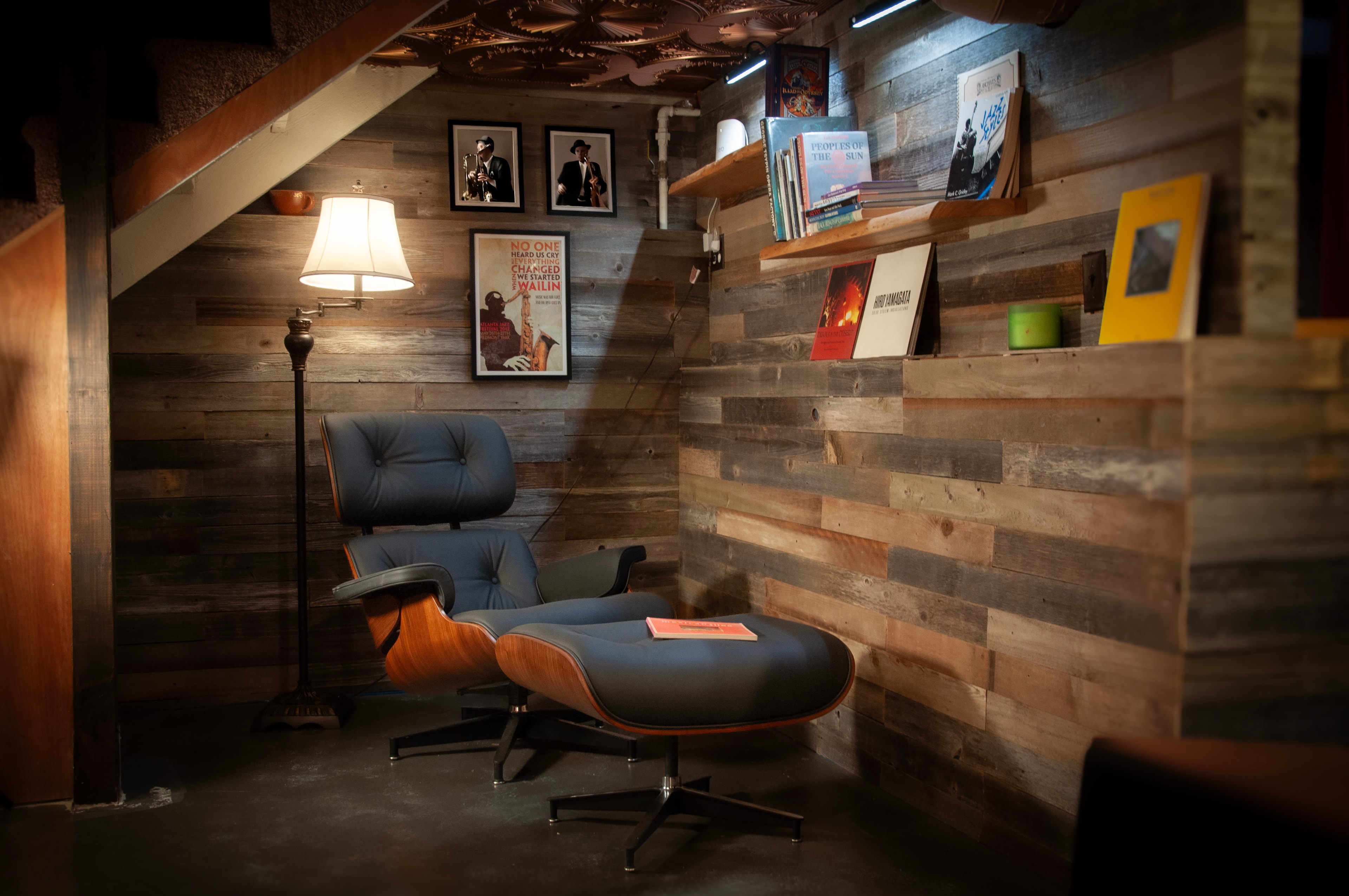 The Vinyl Vault — Eames lounge chair reading nook with reclaimed wood walls