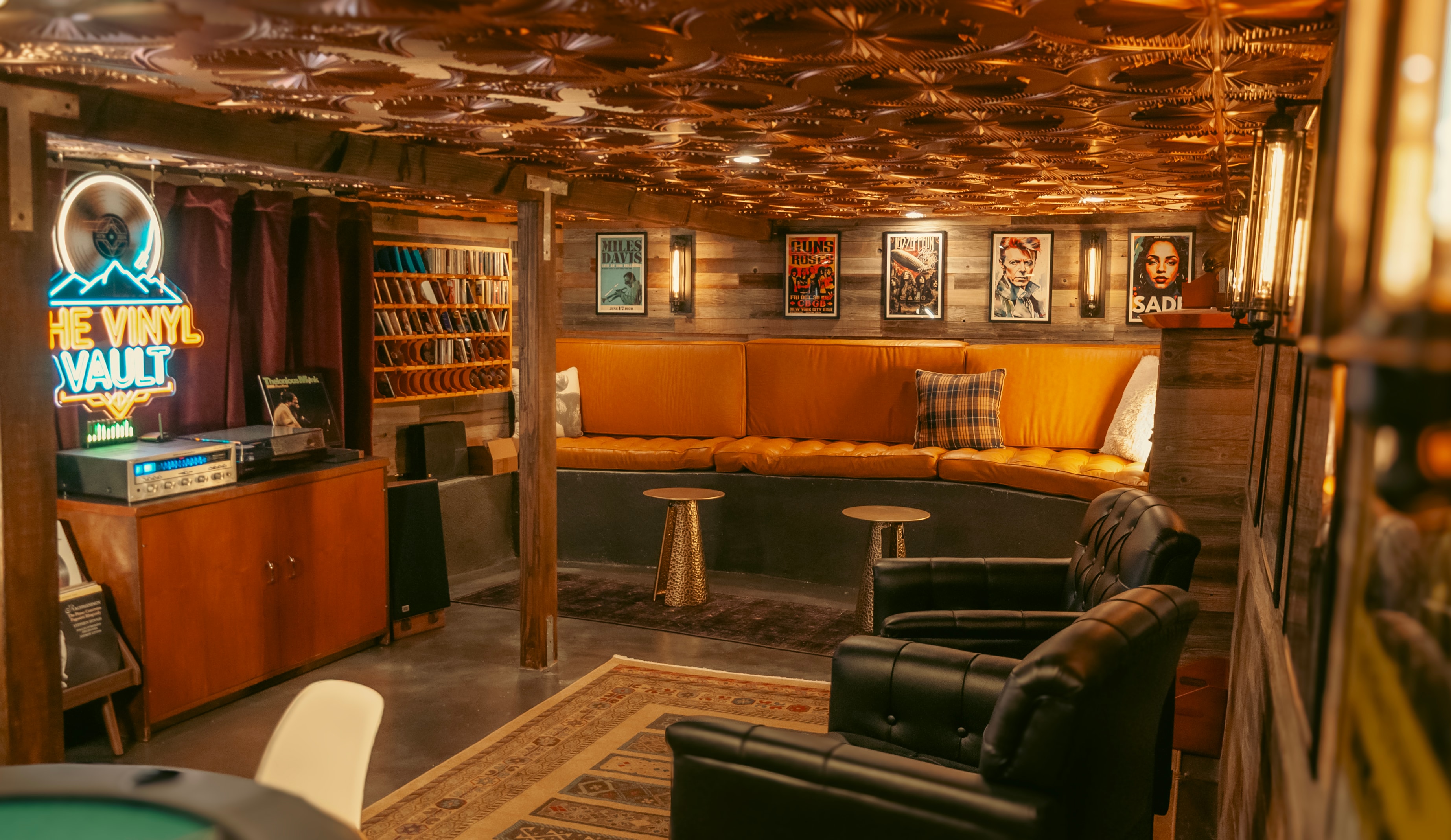 The Vinyl Vault — neon sign and curved orange banquette seating